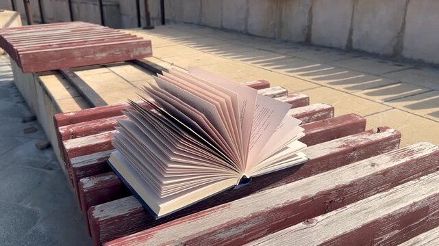 Open book lying on a wooden table surface, reading and education concept, literature, study, knowledge