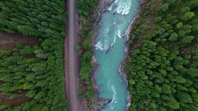 Top down aerial view of the Middle Fork, Flathead River and railroad tracks in Montana, USA.  Near Glacier National Park. June 30, 2024. 