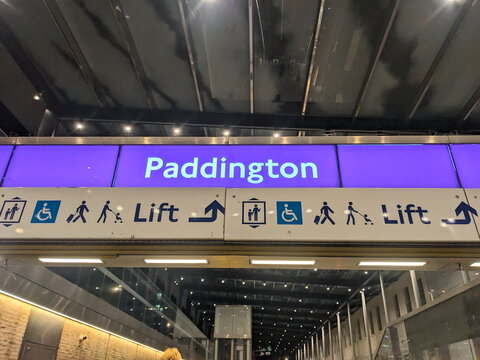 Modern illuminated Paddington station sign on the Elizabeth Line featuring lift and accessibility icons