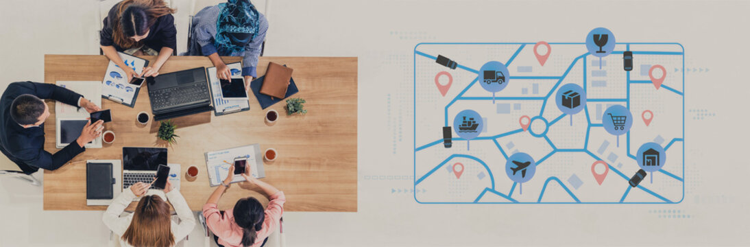 Group of Diverse Professionals Collaborating in a Modern Office with Digital Maps and Technology Resources at the Table. Entropy.