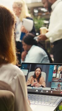 Portrait format: Colleagues in conference call video meeting on laptop in outdoor space, teleconference virtual presentation for strategy planning and brainstorming, startup team productivity.
