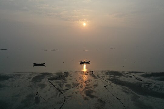 Xiamen Coastal Sunrise Scene with Person and Fishing Boats