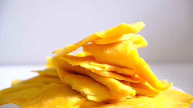 Dried tropical fruits pineapples, papaya, mango rotation in circle on a white background.