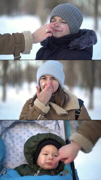 Mother applies protective winter cream to her son's and baby's faces in a snowy park. Family cold weather skincare routine against frost and UV.