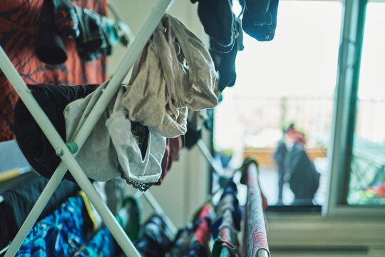 Laundry drying on a folding clothes rack in an apartment