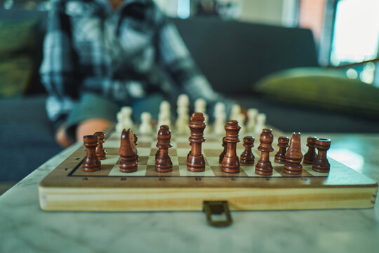 Chess pieces lined up on a wooden board before a game