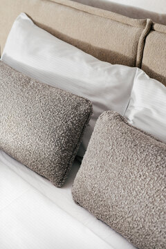 Decorative cushions and pillows on bed in hotel room for a comfortable stay