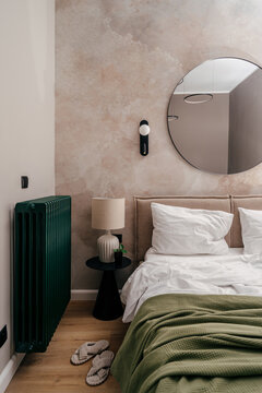 Modern hotel bedroom with a cozy bed and simple decor in a residential space