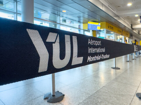 Montreal, Quebec, Canada. July 12, 2026. Close-up selective focus view of a YUL Montreal-Trudeau airport security barrier stanchion belt.