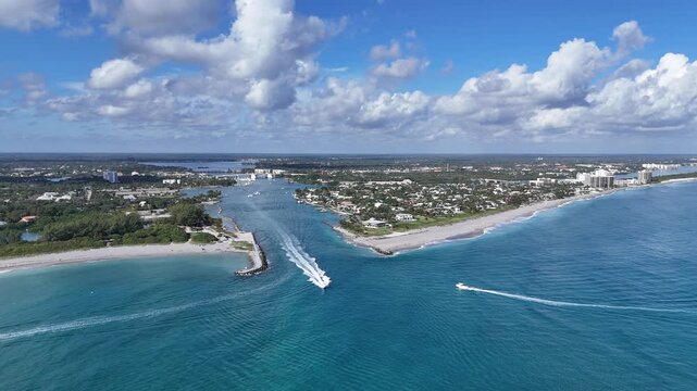 Boats leaving and returning from the Atlantic Ocean at Jupiter Inlet in Palm Beach County, Florida. 