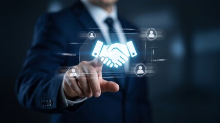 Obraz premium Businessman touching a holographic handshake icon on a digital screen to symbolize business partnership and professional agreement