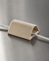 Obraz premium Minimalist cable organizer on metal surface shown as a modern product still life with realistic materials soft cinematic lighting and clean copy space