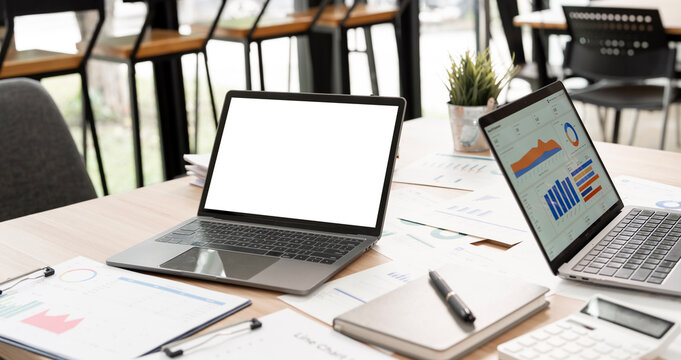 Laptop Mockup with Blank White Screen on Office Desk with Financial Charts