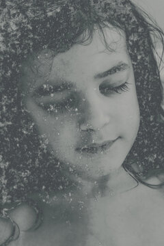 Artistic monochrome portrait of a young girl with her eyes closed, enhanced by a frost‑like texture overlay that creates a dreamlike, emotional atmosphere, delicate and introspective fine art concept