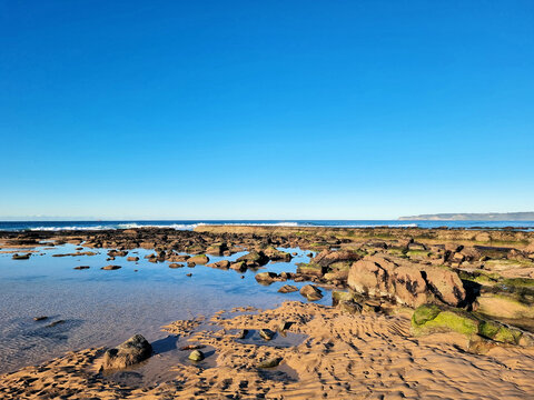 A rock pool at low tide on the rock platform at Susan Gilmore Beach Newcastle New South Wales Australia.