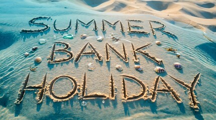 Summer bank holiday written in sand.