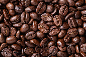 Fototapeta premium Close-up of medium dark roasted coffee bean texture background, Arabica coffee