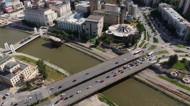 Drone aerial view of Skopje city center with Vardar river, modern bridges, and buildings panorama. North Macedonia capital urban landscape travel