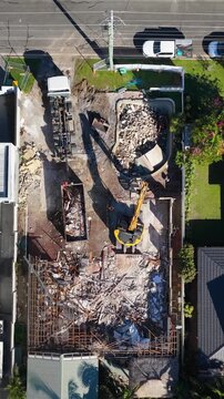 Aerial View of Residential House Demolition with Excavator and Rubble
