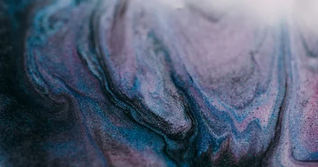 Shimmering fluid blur. Paint stream. Purple blue liquid pigment wave spill with black gray glitter mixing color abstract background. © golubovy