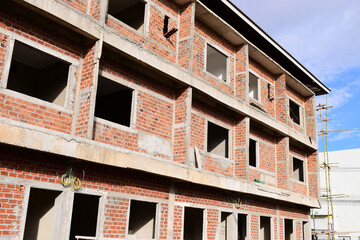 Obraz premium exterior view of brick house under construction with concrete structure