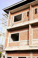 Obraz premium exterior view of brick house under construction with concrete structure