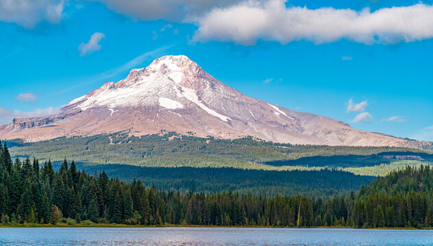 Mount Hood snow-capped volcano reflected above forest and lake in Oregon USA