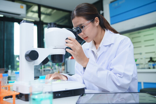 Scientist Conducting Chemical Research with Microscope in Laboratory