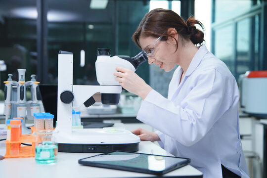 Scientist Conducting Research with Microscope in Laboratory