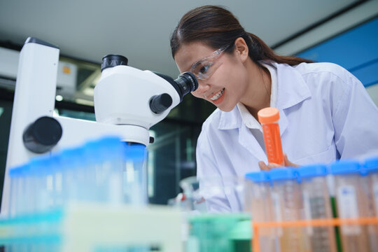 Chemistry Laboratory Scientist Analyzing Samples Using Microscope