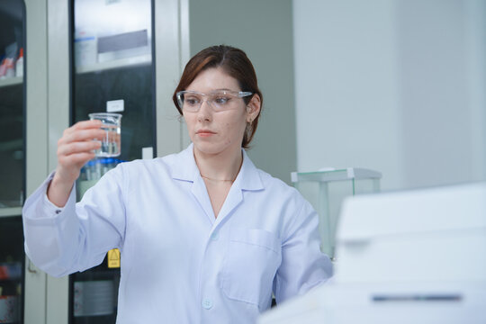 Laboratory technician analyzing chemical solution in a lab
