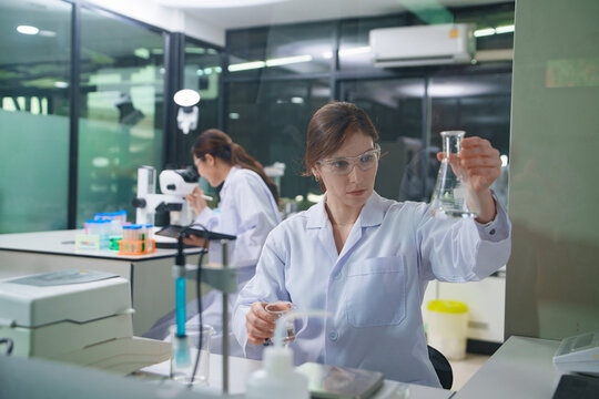 Scientist Conducting Research in Laboratory with Chemical Solutions