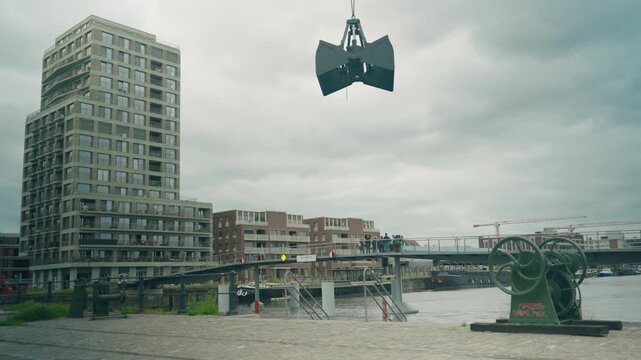 Wide view from Madatibrug in de Oude Dokken showing cranes, docks, water and old mooring machine at harbor - Ghent, Belgium