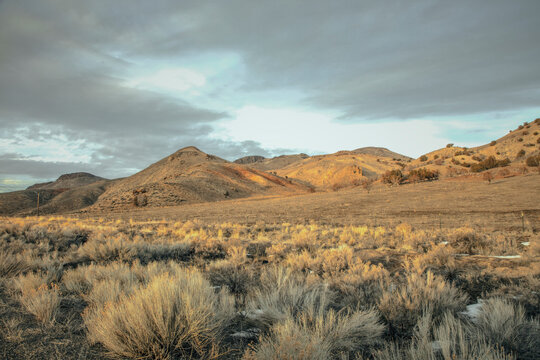Sagebrush hills under a cloudy sky in high desert