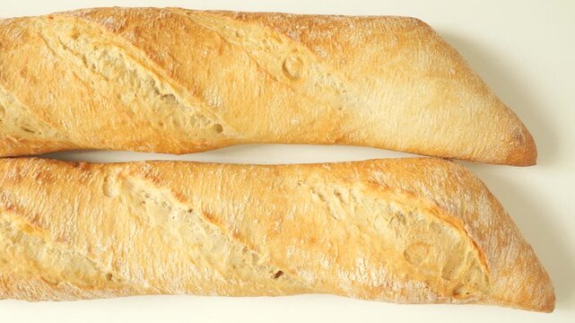 Fresh french baguettes rotating isolated on white background