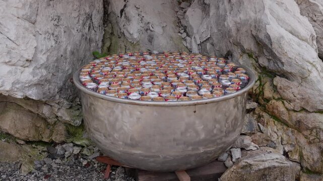 Natural refrigerator filled with cans chilling in cold water rocks in Valbon&euml;, Albania