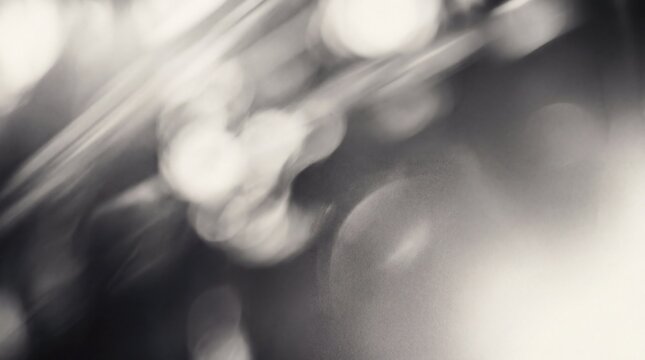 Abstract black and white background with motion blur and bokeh lights, artistic texture for creative design projects.