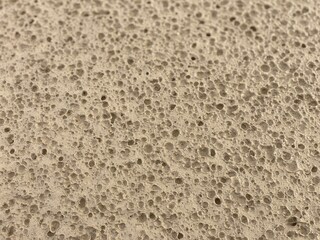 Macro texture of dried porous sandy soil surface with small craters © Islam