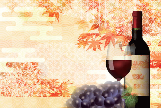 Elegant red wine bottle and glass with autumn maple leaves background