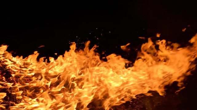 Dynamic Flames in Motion Against Dark Background.