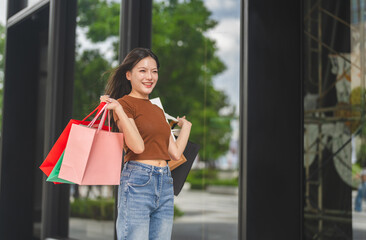Asian happy woman holding shopping bags celebrating beauty shopping and flash sale, Smiling female...