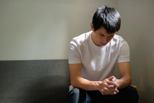 Contemplative Man Sitting Alone with Pensive Expression in Room