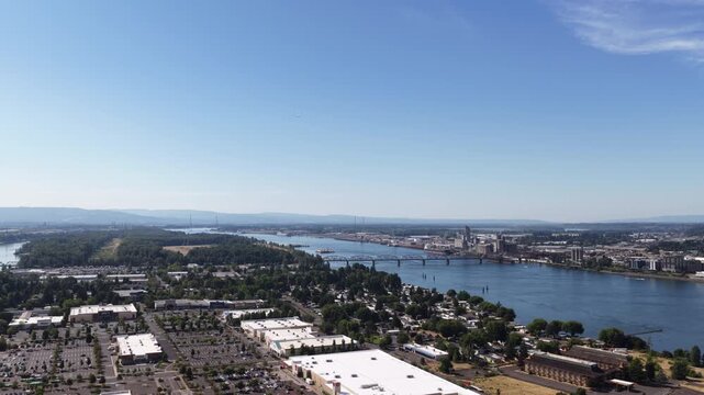 Aerial of Columbia River flowing through Portland Oregon Hayden Bay with extensive urban development and industrial areas