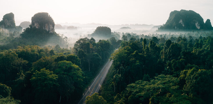 Drone View of Misty Forest Road and Limestone Peaks at Sunrise