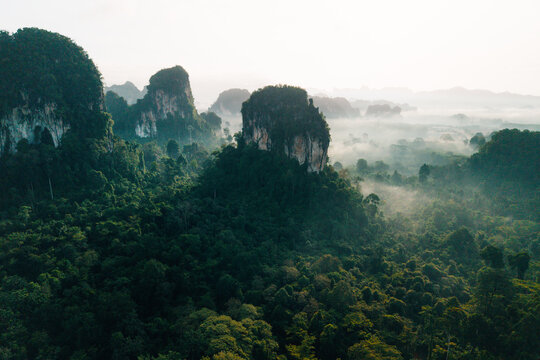 Drone View of Misty Forest Road and Limestone Peaks at Sunrise