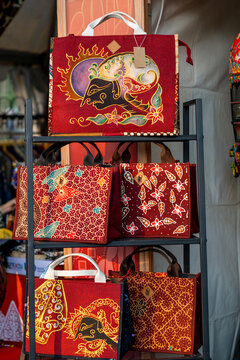 Batik bags are displayed in the shop window. Batik is a traditional Indonesian technique for decorating fabric.