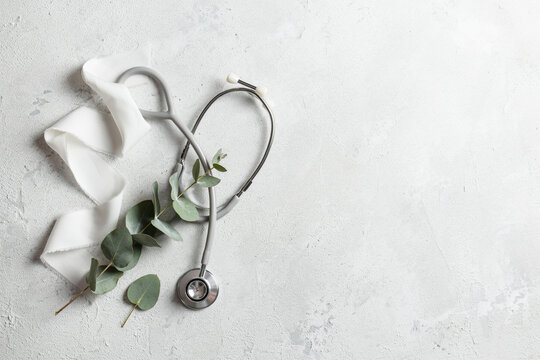 Minimalist Flat Lay with White Ribbon and Stethoscope on Textured Background for World Lung Cancer Day Awareness, Healthcare Copy Space