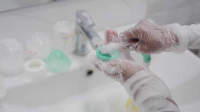 Close Up of Asian Mother Wearing Disposable Gloves Before Baby Care for Safe Home Hygiene