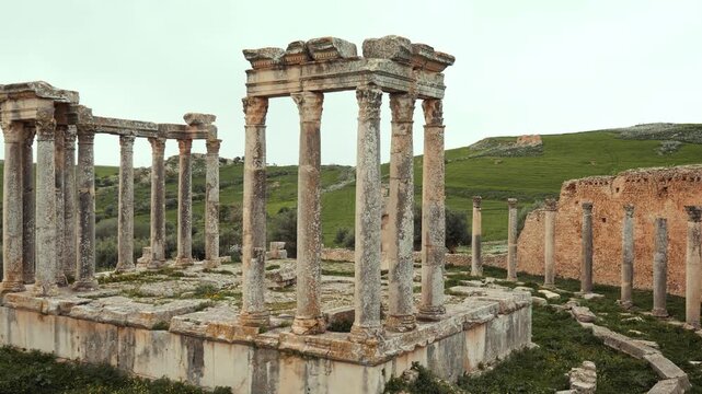 View of historical Temple of Juno Caelestis with columns and ruined stone walls in Dougga, Tunisia
