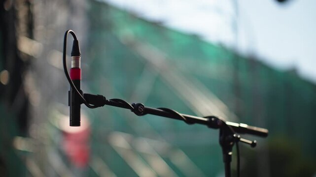 Hanging Microphone on Stand at Outdoor Stage with Bokeh